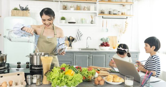 asian-young-single-mother-making-food-while-taking-care-child-kitchen